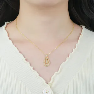 Detailed view of an elegant Hamsa hand gold-plated necklace worn on a model's neck