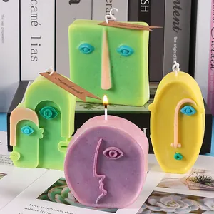 Detailed macro shot of creative abstract face scented candles in pastel green and purple