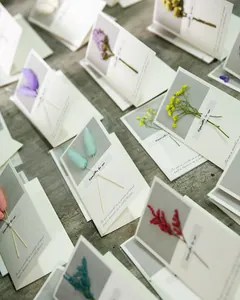 Detailed view of elegant handmade greeting cards with colorful real dried flower accents