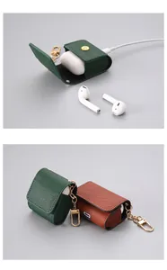 Detailed macro view of the premium leather texture and gold keychain on AirPods cases.