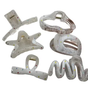 Set of colorful rhinestone hair claws in star, bow, and geometric shapes