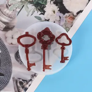 Detailed view of DIY silicone resin molds for three vintage style key pendants