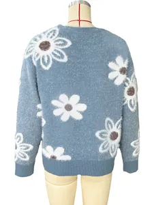 Detailed back view of a fuzzy blue knit cardigan featuring white daisy floral patterns