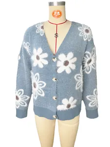 Detail of blue mink velvet cardigan featuring large white flower knit patterns