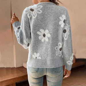 Detailed back view of a blue knitted cardigan featuring white daisy floral patterns