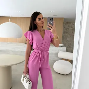 Elegant pink V-neck jumpsuit with ruffle sleeves and tie-waist detail