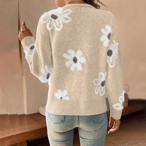 Detailed back view of a cozy loose beige knit cardigan with large white flower patterns