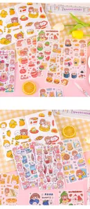 Detailed view of colorful cartoon sticker sheets with cute character and food themes