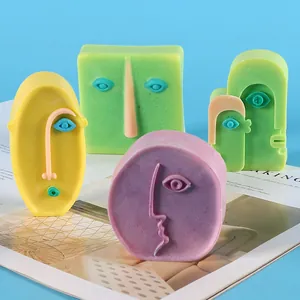 Close-up view of colorful abstract face-shaped candles crafted from creative silicone molds