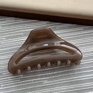 Elegant brown translucent hair claw clip with simple geometric design for women.