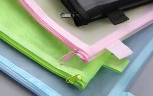 Detailed close-up showing the zippers and mesh texture of various colorful file bags.