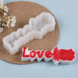 Close-up of DIY silicone mold for Love letter and rose shape candle crafts and resin art