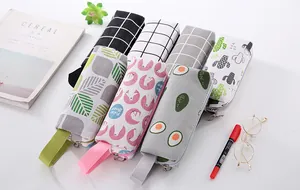Detailed close-up showing various canvas pencil cases with cute cartoon and grid patterns