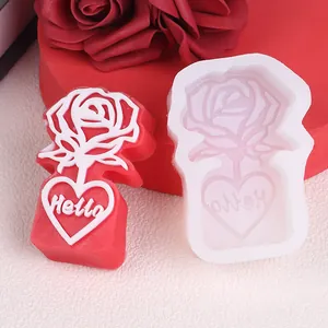 Close-up of rose and heart silicone mold with Hello text for DIY candle making