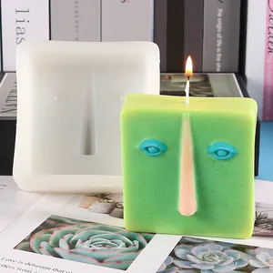 Detailed view of the abstract face silicone mold with a finished green candle