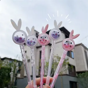 Close-up detail of cute cartoon rabbit-shaped gel pens in aesthetic pink and white colors