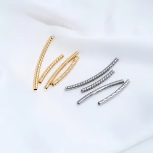 Macro view of stainless steel twisted and snake bone pattern curved tube beads for jewelry making