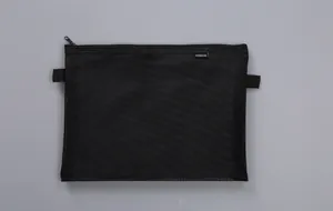 Detail showing a semi-transparent black mesh document bag with top zipper and loops