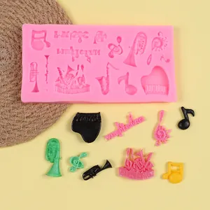 Close-up of pink music themed silicone mold with finished colorful instrument shapes