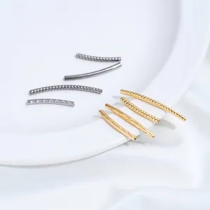 Detailed macro of gold and silver titanium steel twisted tubes for DIY jewelry design