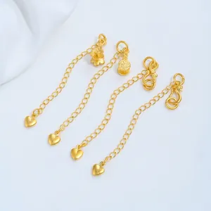 Close-up view of 24K gold plated jewelry extension chains with decorative heart charms