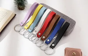 Group of colorful leather strap keychains in various vibrant shades with metal rings