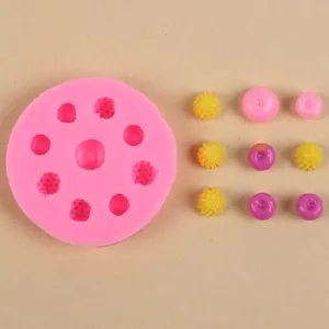 Nahaufnahme einer rosa Silikonform mit fertigen Miniatur-Harzbeeren und Früchten