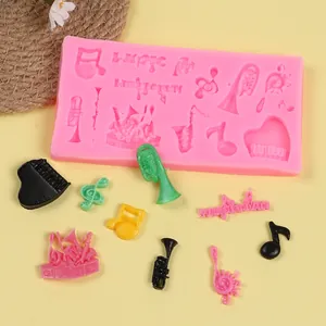 Detail view of pink music-themed silicone mold with musical instruments and notes