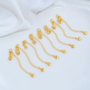 Close-up of 24K gold-plated jewelry extension chains with various animal charms.