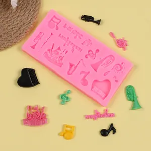Detail of pink silicone mold showing various musical notes and instrument patterns