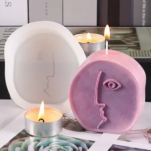 Macro detail of abstract face silicone mold and finished purple scented candle