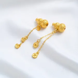 Close-up of 24K gold plated gourd pendants with auspicious cloud and coin charms.