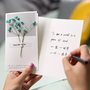 Handmade greeting card with real dried blue gypsophila flowers for romantic gifts