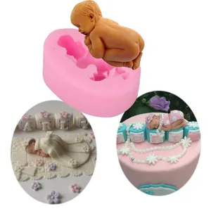 Detailed view of sleeping baby silicone mold and finished cake decorations.