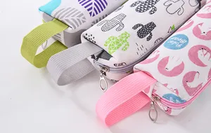 Close-up detail of colorful canvas pencil cases with cartoon cactus and polar bear prints