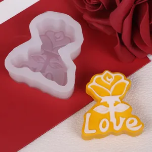 Detail view of a rose silicone mold and a finished yellow rose candle with 'Love' text.
