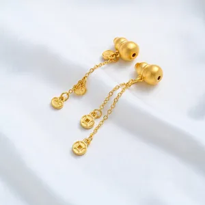 Detailed macro view of 24K gold plated gourd and ancient coin tassels for DIY jewelry