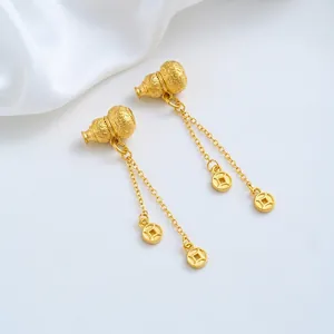 Close-up of 24K gold-plated gourd and coin pendants with tassels for DIY jewelry