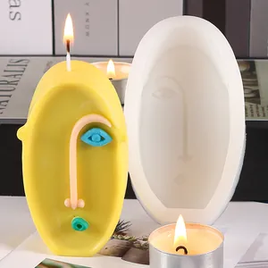 Abstract face silicone mold shown next to a finished yellow scented candle for DIY decor