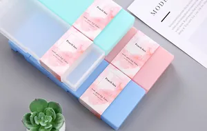 Close-up of candy-colored PP pencil boxes featuring pink, mint green, and blue finishes.
