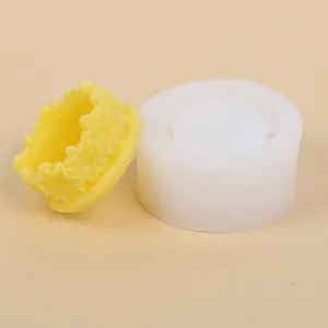 Detailed view of a round floral wreath silicone mold and a yellow flower ring casting