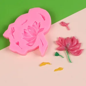 Detail view of lotus and goldfish silicone mold with finished fondant decorations
