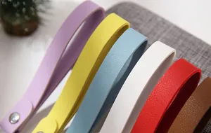 Macro view showing the vibrant colors and lychee texture of leather keychain straps.