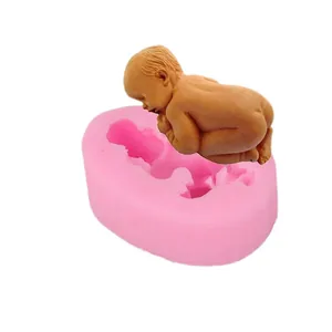 Close-up detail of a pink silicone baby mold and a realistic newborn figurine result