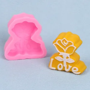 Detail of rose flower and 'Love' letter silicone mold with its finished yellow candle