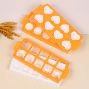 Detail of orange and white 10-cavity heart and square shaped ravioli and chocolate molds