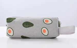 Close-up detail of a durable canvas pencil case featuring a cute cartoon avocado pattern print