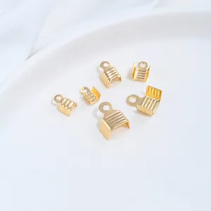 Close-up of gold-plated stainless steel ribbon crimp ends for jewelry making