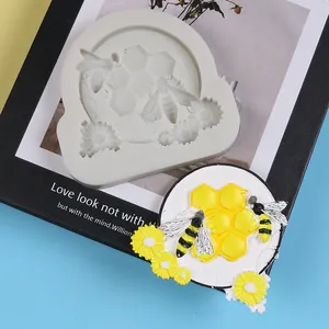 Detailed view of bee and honeycomb silicone mold with finished cake topper example