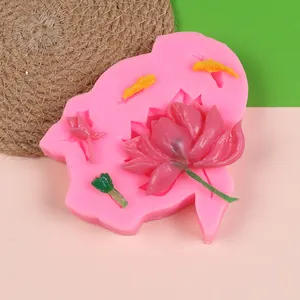 Detail of pink silicone mold featuring lotus and koi fish for fondant cake decoration